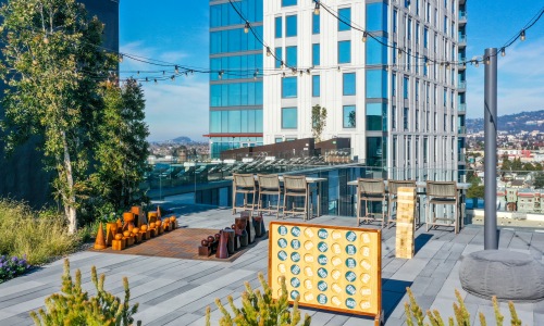 rooftop gaming area with cornhole, jenga, oversized chess, etc.